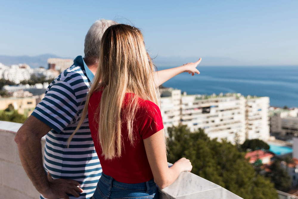 man and woman watch the sea